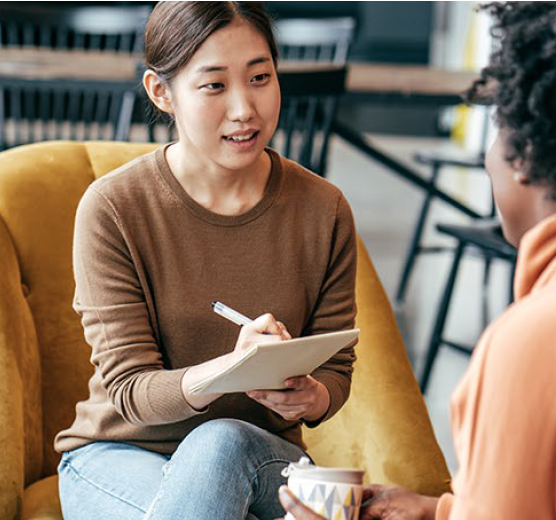 Woman interviewing patient and taking notes